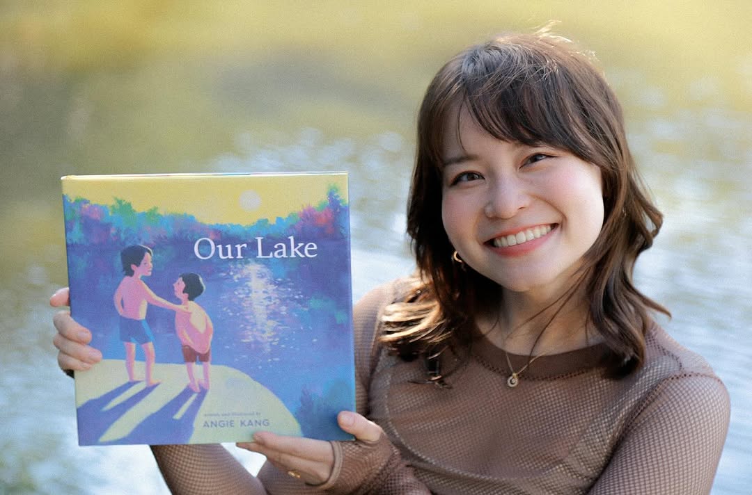 Kang holding a copy of her book