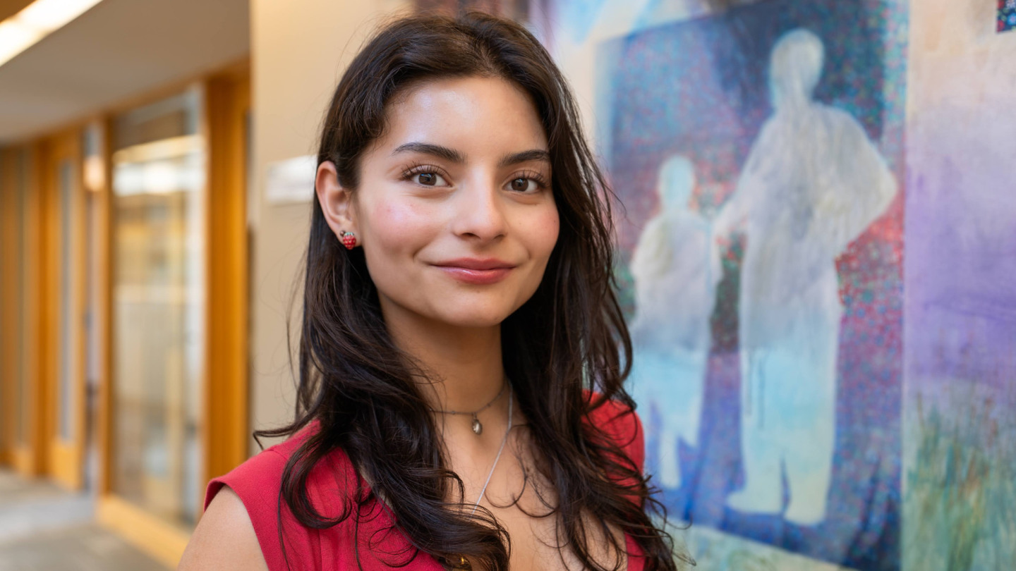 Sara Homma in front of one of her paintings