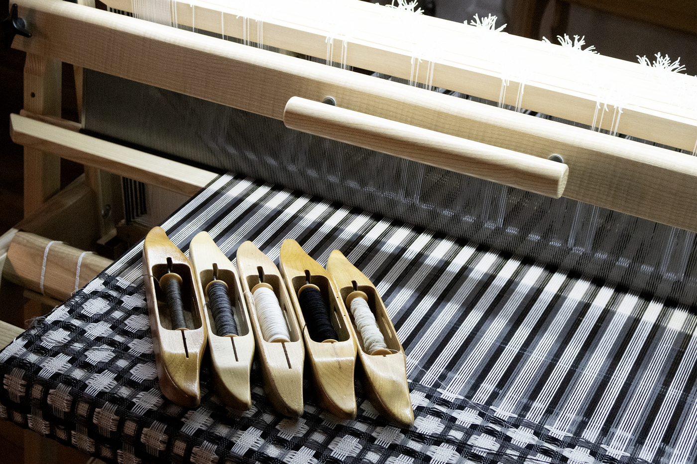 shuttles resting on a textile loom