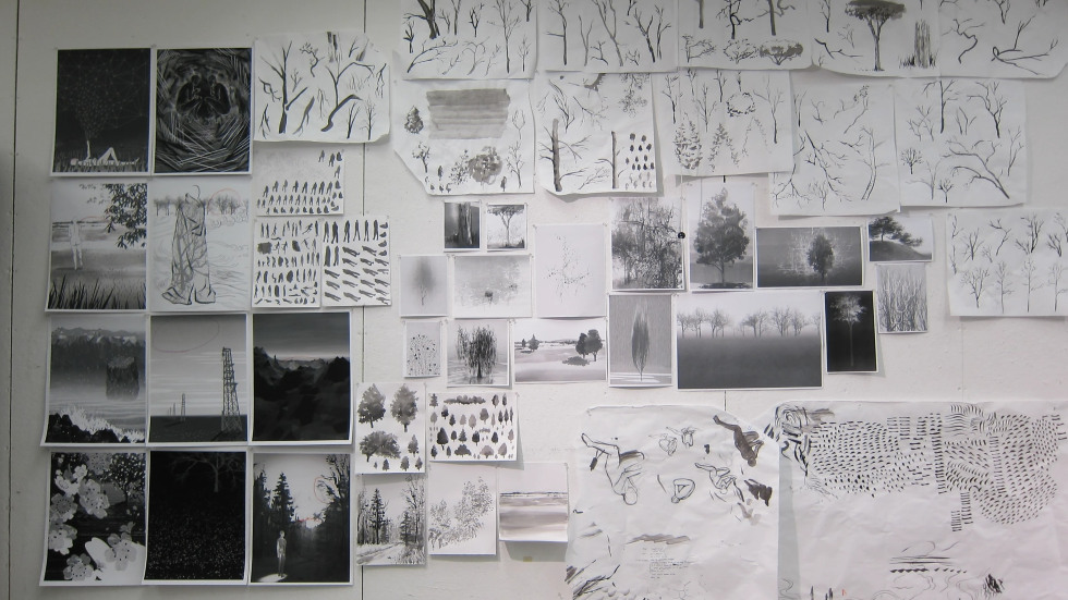 black and white image of drawings tacked to a wall